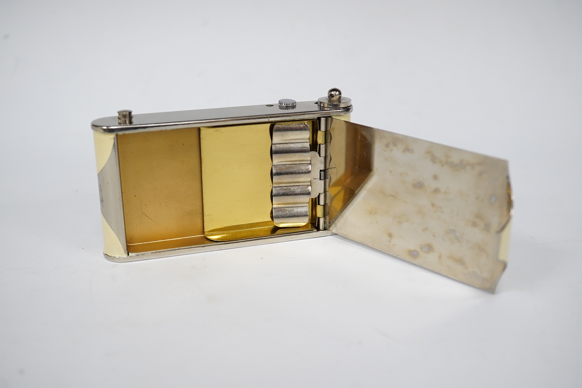 An Art Deco enamelled and chromed combined compact, a cigarette case and a timepiece, 9.5cm. Condition - minor flaking, movement going